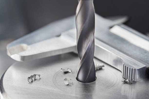 istock drill bit make holes in steel billet on industrial drilling machine with ruler and caliper. Metal work industry. multi cutting tool and end mill. 1332069791