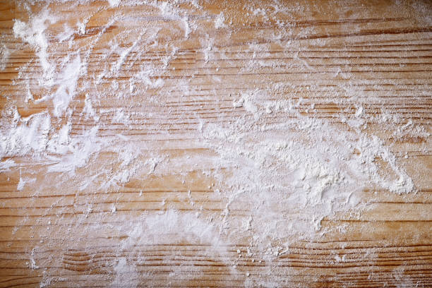 Pastry board with flour. Wooden background, top view