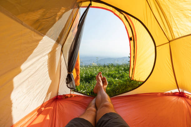 Man resting lying in the camping tent