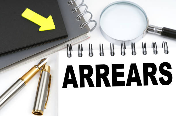 istock On the table are a pen and a notebook with the inscriptions - Arrears 1332072166