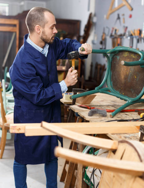 istock Carpenter repairing antique chair 1332072300