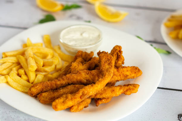 istock Fried chicken sticks whit French fries 1332073315