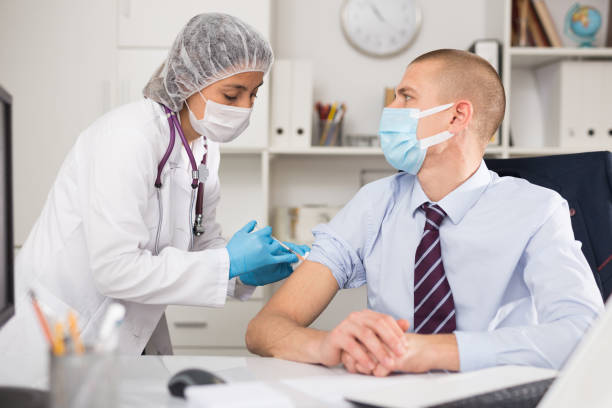 istock Vaccination of an office worker in company office 1332073347