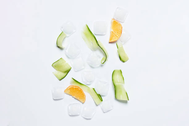 istock Lemon and cucumber slices with ice 1332073665