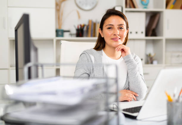 istock Woman sitting at workplace with computer in office 1332074424