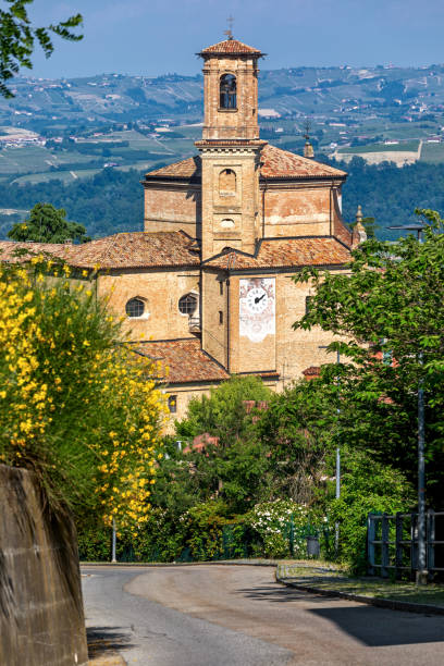 narrow road and old brick church in guarene, italy. - religion christianity bell tower catholicism imagens e fotografias de stock