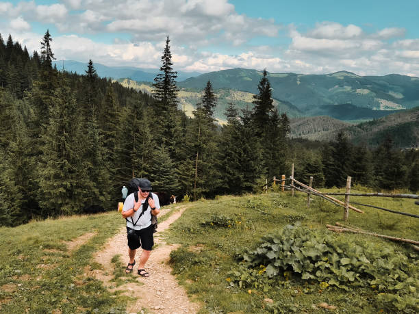 istock young hiker man in mountains. summer trekking path 1332075990