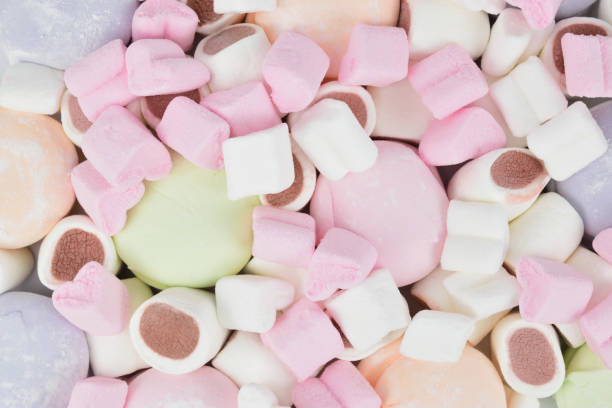istock Top view of different types of marshmallows in a mess spread out on a table surface 1332076989