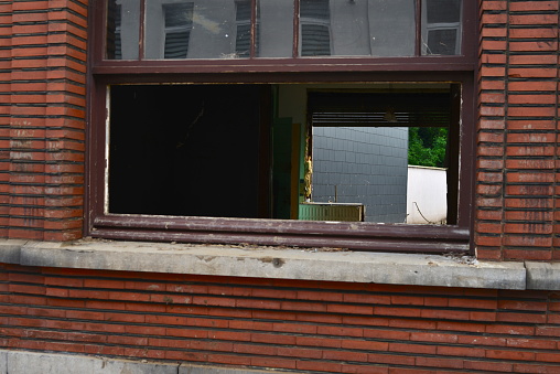 Pepinster, Liège, Belgium- August,01, 2021: 2 weeks after flood still damage visible in the streets. Houses without glass in window frames. Police ribbon tape sealed properties.