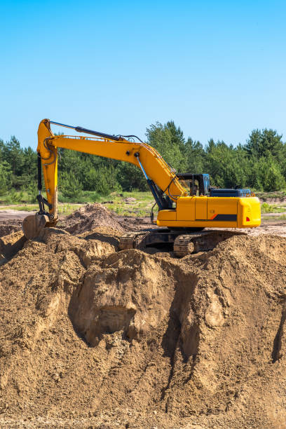 istock An industrial yellow excavator develops in a sandpit quarry. Industry, technology, mining. Heavy industrial machinery 1332079312