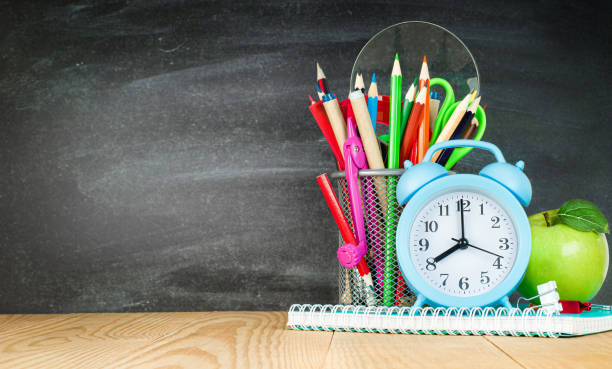 istock pencil holder, alarm clock and apple 1332080179