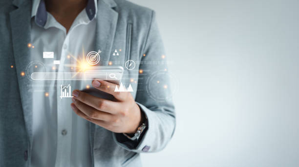 istock Human using mobile phone technology for digital marketing of darts aiming at the target. business management  goal strategy and action plan. Global customer network connection  on virtual interface. 1332080200