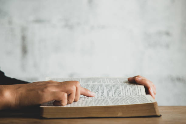 istock Women reading the old heavy book on white background. 1332081824