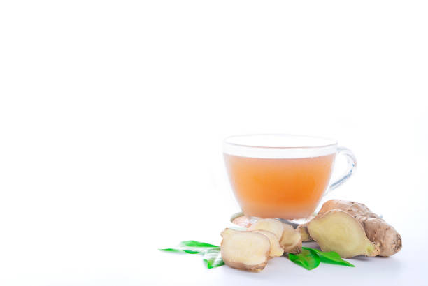 istock Closeup hot ginger tea in glass cup with fresh organic ginger root isolated on white background, copy space for text. 1332083528