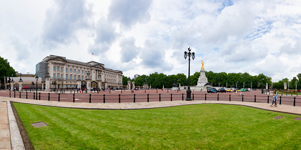 London, UK - April, 2019: A Guard standing outside Buckingham Palace. English guard patrolling in London. Solider of Buckingham palace, London England.