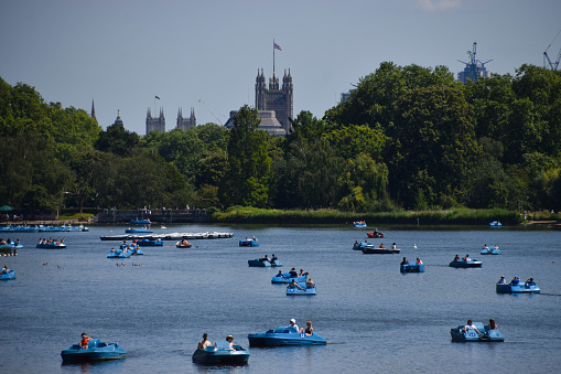 Six rowing boats with bright blue inners moored up together.