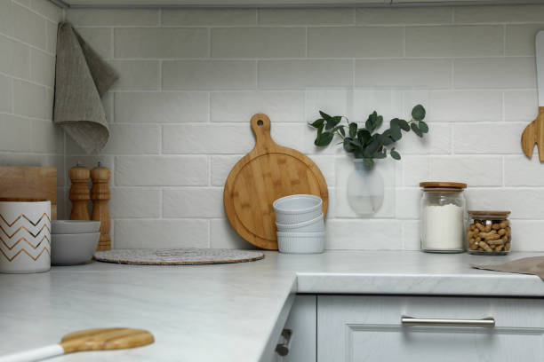 istock Silicone vase with eucalyptus branches on wall over countertop in kitchen 1332084902