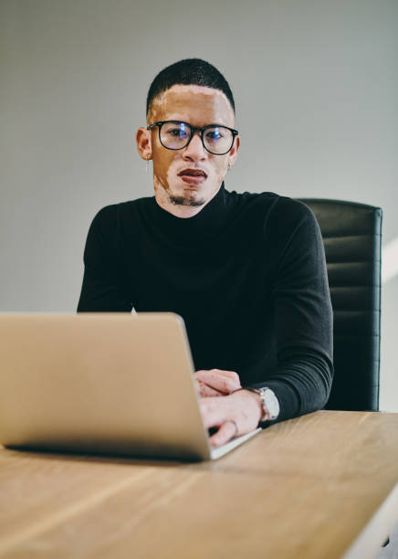 istock Shot of a young businessman using a laptop in a modern office 1332086151