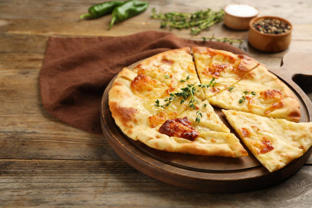 istock Delicious khachapuri with cheese on wooden table 1332086916