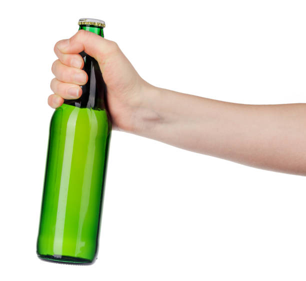 istock Hand holding a beer bottle without label isolated on white background 1332087535