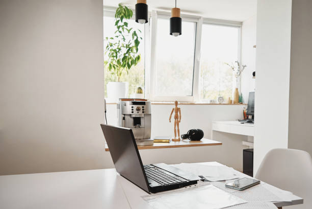 istock Home office. Laptop on table in the kitchen 1332088008