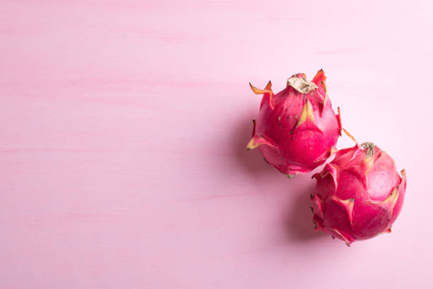 istock Ripe dragon fruit or pitaya on pink background 1332088801