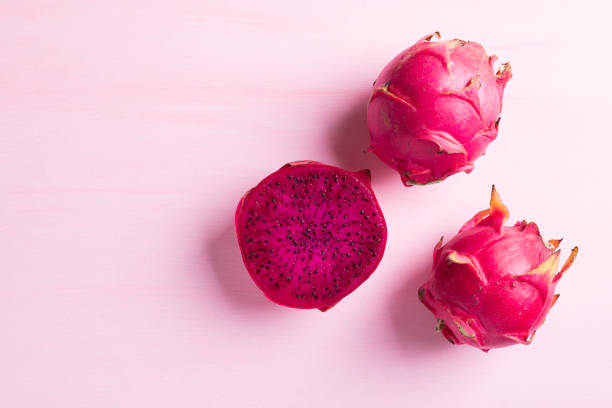 istock Ripe red dragon fruit or pitaya on pink background 1332088999
