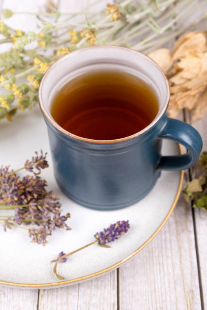 istock Green tea or herbal tea with cup, sugar and dry herbs 1332089931
