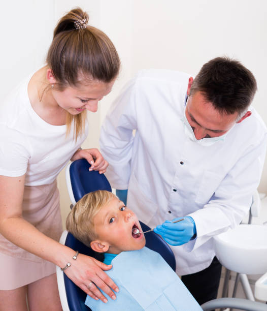 istock Woman with child are visiting dentist 1332091349