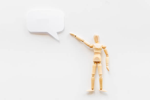 istock Wooden man figure with speech bubble banner 1332092348