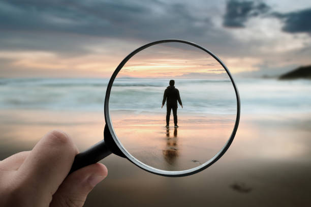 istock Magnifying glass focusing on a man's silhouette 1332092362