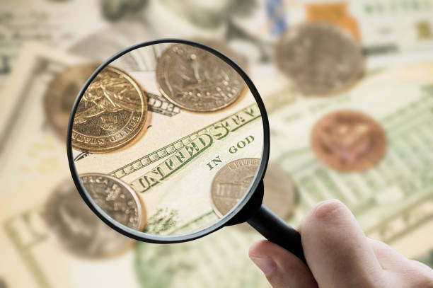 istock Magnifying glass focusing on money 1332092400
