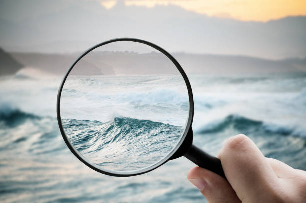 istock Magnifying glass focusing on sea waters 1332092401