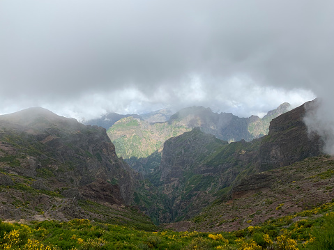 Clouds over the mountains on Madeira island at the Ninho da Manta, or Eagle’s Nest close to the Pico do Arieiro on the Vereda do Areeiro - Pico Ruivo, a populair walkway over the highest mountains of the island.