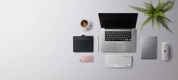 istock Flat lay top view office desk working space with laptop on gray background. Copy space. 1332092927