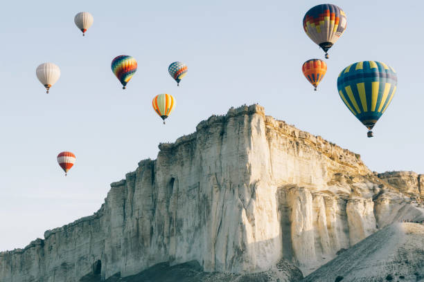 istock Colorful balloons flying over the mountain. 1332094163