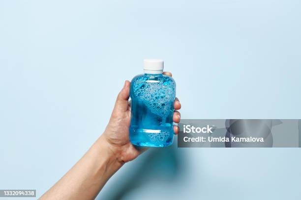 Hand Holds Mouth Refreshing Liquid Stock Photo - Download Image Now - Mouthwash, Dental Health, Washing