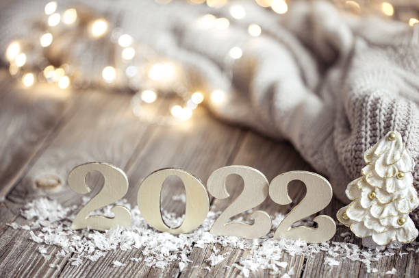 istock Cozy holiday composition with the numbers 2022 on a blurred background in bokeh. 1332096033