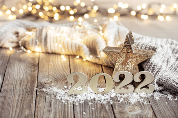 istock Cozy festive composition with the numbers 2022 and decor details close up. 1332096036