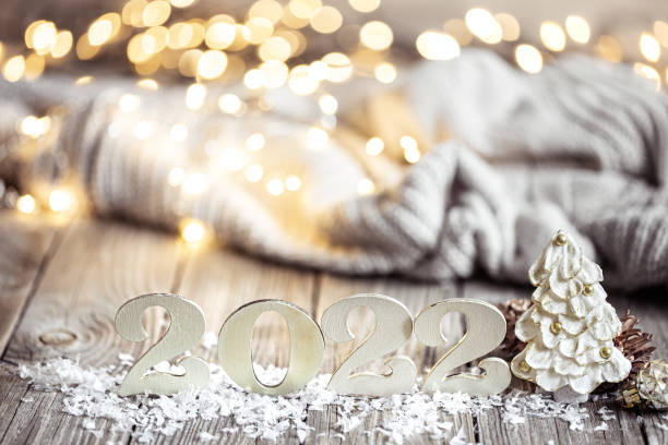 istock Cozy festive composition with the numbers 2022 and decor details close up. 1332096038