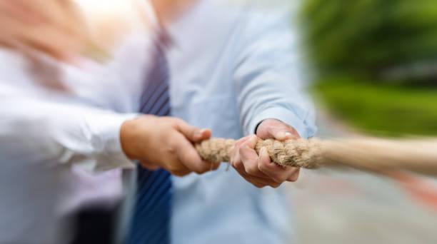istock Group of business people pulling the rope 1332097124