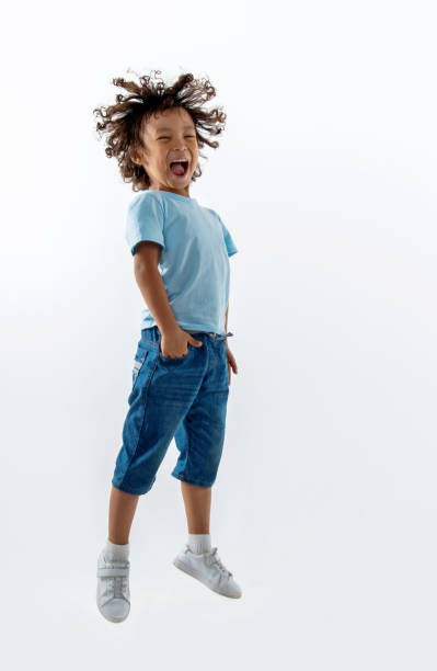 istock Little boy jumping on white background 1332097212