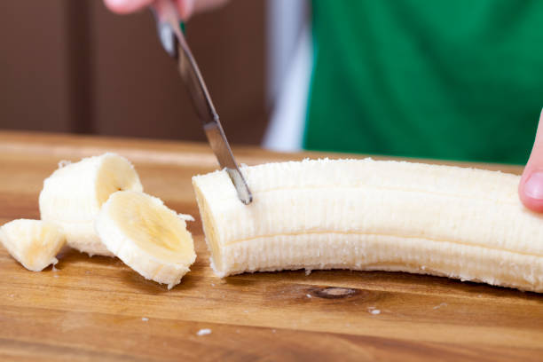 istock one banana is cut on a food slicing board 1332097650