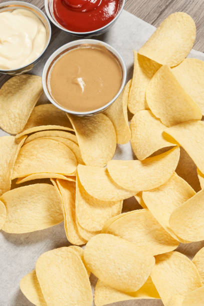 istock Potato chips for snack with ketchup and sour cream 1332100852