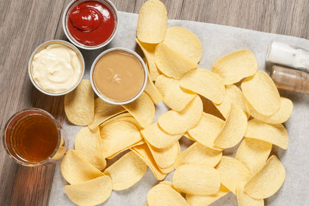 istock Potato chips for snack with ketchup and sour cream 1332100854