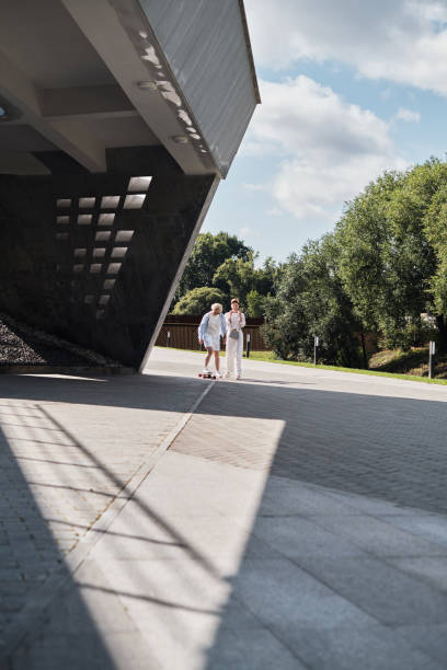 istock Two women with longboard walking outdoor 1332101294