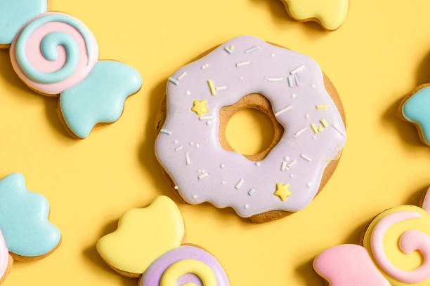 Colorful gingerbread cookies covered with bright glaze, flat lay.
