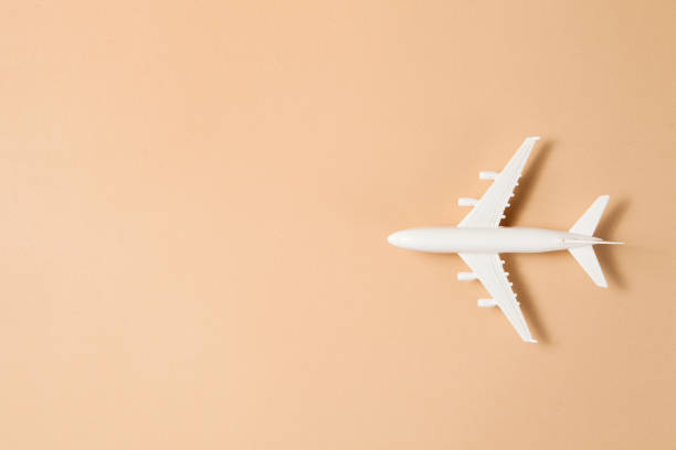 istock Flat lay design of travel concept with plane on brown background. 1332102769