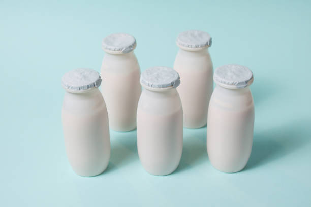 istock Bottles with probiotics and prebiotics dairy drink on light blue background. 1332104240
