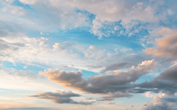 istock Evening sky with some yellow, white, grey and dark clouds 1332104291